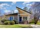 Charming single-story home featuring a unique roofline, blue front door, and lush landscaping at 1809 Coltrane Ct, Raleigh, NC 27610