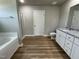 Modern bathroom with granite vanity, tile floor, shower, and soaking tub featuring an open concept at 186 Coharie Dr, Lillington, NC 27546