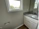 Bathroom with granite countertops, white vanity, modern fixtures and a large window at 186 Coharie Dr, Lillington, NC 27546