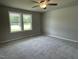 Spacious bedroom with plush carpeting, a ceiling fan, and bright natural light at 186 Coharie Dr, Lillington, NC 27546