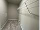 Carpeted walk-in closet featuring a practical wire shelf for organized storage and neutral wall paint at 186 Coharie Dr, Lillington, NC 27546