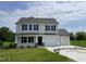 Charming two-story home featuring a two-car garage and well-manicured lawn at 186 Coharie Dr, Lillington, NC 27546
