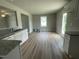 Modern kitchen featuring a large countertop space with stainless sink and wood flooring at 186 Coharie Dr, Lillington, NC 27546