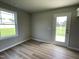 Well-lit living area featuring a glass door leading to the backyard and wood flooring at 186 Coharie Dr, Lillington, NC 27546