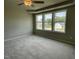 Spacious primary bedroom featuring neutral walls, carpet, a ceiling fan, and natural sunlight at 186 Coharie Dr, Lillington, NC 27546