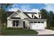 Charming two-story home featuring a white exterior, a two-car garage, and a professionally landscaped front yard at 2016 Kapalua Way # 195, Durham, NC 27703