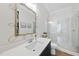 Bright bathroom featuring white countertops, a glass-enclosed shower, and an ornate gold mirror at 2040 Pleasant Forest Way, Wake Forest, NC 27587