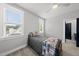 Bright bedroom with hardwood floors, a ceiling fan, two sunny windows and gray carpet at 2040 Pleasant Forest Way, Wake Forest, NC 27587