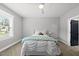 A bright bedroom showcases a ceiling fan, plush carpet, natural light, and a neutral wall color at 2040 Pleasant Forest Way, Wake Forest, NC 27587