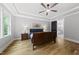 Primary bedroom featuring tray ceiling, hardwood floors, a picture window and ensuite bathroom at 2040 Pleasant Forest Way, Wake Forest, NC 27587