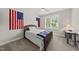 Cozy bedroom with a ceiling fan, natural light, and two flags on the wall at 2040 Pleasant Forest Way, Wake Forest, NC 27587