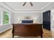 Primary bedroom featuring tray ceiling, hardwood floors, a picture window and dark trim doors at 2040 Pleasant Forest Way, Wake Forest, NC 27587