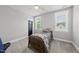 Comfortable bedroom with a gray ceiling fan, two sunny windows, and soft gray carpet at 2040 Pleasant Forest Way, Wake Forest, NC 27587