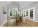 Bright dining room with vaulted ceiling, hardwood floors, and french doors to backyard patio at 2040 Pleasant Forest Way, Wake Forest, NC 27587