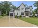 New construction home showcasing modern farmhouse design with a spacious driveway and attached two-car garage at 2040 Pleasant Forest Way, Wake Forest, NC 27587