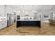 Bright, open kitchen with white cabinetry, stainless steel appliances, and a large center island at 2040 Pleasant Forest Way, Wake Forest, NC 27587