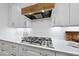 Close-up of a modern kitchen featuring white cabinets, stainless steel appliances, and elegant countertops at 2040 Pleasant Forest Way, Wake Forest, NC 27587