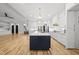 Spacious kitchen with white cabinetry, stainless steel appliances, and center island open to the living area at 2040 Pleasant Forest Way, Wake Forest, NC 27587