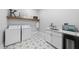 Modern laundry room with star-patterned tile floor, white cabinetry, sink and washer/dryer at 2040 Pleasant Forest Way, Wake Forest, NC 27587