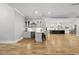 Expansive living area flows into a wet bar, kitchen, and dining area with hardwood floors, and open concept living at 2040 Pleasant Forest Way, Wake Forest, NC 27587