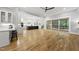 Open living area seamlessly connects to the kitchen, dining area, and screened porch with light hardwood flooring at 2040 Pleasant Forest Way, Wake Forest, NC 27587