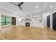 Modern living room features sliding glass doors, built-in shelving, a fireplace, and hardwood floors throughout at 2040 Pleasant Forest Way, Wake Forest, NC 27587