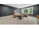 Living room boasts carpet, plush seating, dark neutral walls, a window with natural light, and a ceiling fan at 2040 Pleasant Forest Way, Wake Forest, NC 27587