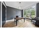 Bright home office with large window, hardwood floors, modern light fixture and gray accent wall at 2040 Pleasant Forest Way, Wake Forest, NC 27587