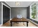 Bright home office with hardwood floors, a modern light fixture, and a black accent door at 2040 Pleasant Forest Way, Wake Forest, NC 27587