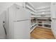 Spacious pantry with custom shelving, a wooden countertop, and an additional refrigerator for added convenience at 2040 Pleasant Forest Way, Wake Forest, NC 27587