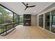 This screened porch features a fireplace, ceiling fan, wood flooring, and sliding glass doors at 2040 Pleasant Forest Way, Wake Forest, NC 27587