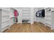Spacious walk-in closet with custom built-in shelving and hardwood floors at 2040 Pleasant Forest Way, Wake Forest, NC 27587