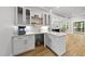 Charming wet bar features shaker cabinets, quartz countertop, glass door cabinets, and open access to a stunning living area at 2040 Pleasant Forest Way, Wake Forest, NC 27587