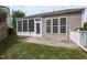 View of the backyard featuring a patio, screened-in porch, and a well maintained lawn at 207 Callum Pl, Cary, NC 27519
