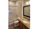 Well-lit bathroom featuring a shower-tub combo, granite countertop, and modern fixtures at 207 Callum Pl, Cary, NC 27519