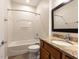 Full bathroom features a bathtub, vanity with granite countertop, and tiled floors at 207 Callum Pl, Cary, NC 27519