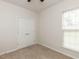 This bedroom features plush carpet, a double closet, and a window for natural light at 207 Callum Pl, Cary, NC 27519