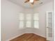 Bedroom featuring hardwood floors, white walls, ceiling fan, and natural light from a bay window at 207 Callum Pl, Cary, NC 27519
