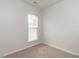 Cozy bedroom with neutral carpet, a bright window, and fresh paint at 207 Callum Pl, Cary, NC 27519