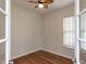 Bedroom featuring hardwood floors, white walls, ceiling fan, and natural light from a single window at 207 Callum Pl, Cary, NC 27519