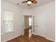 View of bedroom featuring hardwood floors, white walls, ceiling fan, and natural light from a single window at 207 Callum Pl, Cary, NC 27519