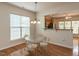 Cozy dining area featuring hardwood floors, natural light, and an open kitchen concept at 207 Callum Pl, Cary, NC 27519