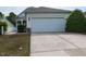 View of driveway and facade of home featuring a two-car garage and a landscaped front yard at 207 Callum Pl, Cary, NC 27519