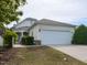 Charming home featuring a two-car garage, landscaped yard, and inviting entrance at 207 Callum Pl, Cary, NC 27519