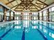 Spacious indoor pool features multiple lanes and large windows, providing ample natural light for year-round enjoyment at 207 Callum Pl, Cary, NC 27519
