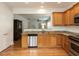 Bright and airy kitchen with stainless steel appliances, granite countertops, and hardwood flooring at 207 Callum Pl, Cary, NC 27519