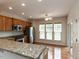 Well-lit kitchen featuring granite counters, stainless steel appliances, and hardwood floors at 207 Callum Pl, Cary, NC 27519