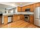 Modern kitchen with stainless steel appliances, granite countertops, and hardwood floors at 207 Callum Pl, Cary, NC 27519