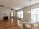 Bright living area with hardwood floors, ceiling fan, and elegant dining set at 207 Callum Pl, Cary, NC 27519