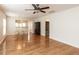 Open-concept living room showcasing hardwood floors and a ceiling fan with great natural lighting at 207 Callum Pl, Cary, NC 27519